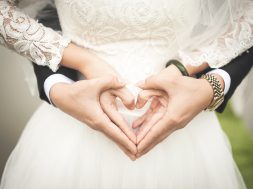 midsection-of-woman-making-heart-shape-with-hands-256737