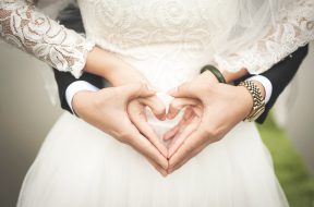 midsection-of-woman-making-heart-shape-with-hands-256737