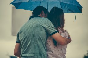 man-hugging-woman-while-holding-umbrella-1534633