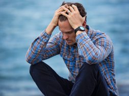 man-in-blue-and-brown-plaid-dress-shirt-touching-his-hair-897817