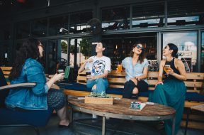 four-women-chatting-while-sitting-on-bench-1267697 (1)