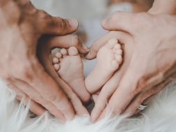 person-holding-baby-s-feet-2456327