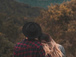 couple-standing-on-top-of-hill-1995718