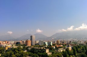 grey-concrete-building-in-the-middle-of-the-city-under-blue-131920