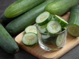 fresh cucumbers sliced on dark background