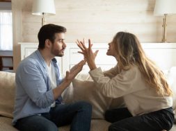 Emotional annoyed stressed couple sitting on couch, arguing at home. Angry irritated nervous woman man shouting at each other, figuring out relations, feeling outraged, relationship problems concept.