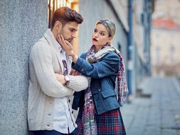 Woman is consoling her sulking boyfriend on the street