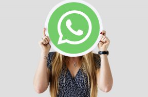 Woman showing a WhatsApp Messenger icon