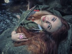 Asia beautiful young sexy girl lying down on a rock in water fall